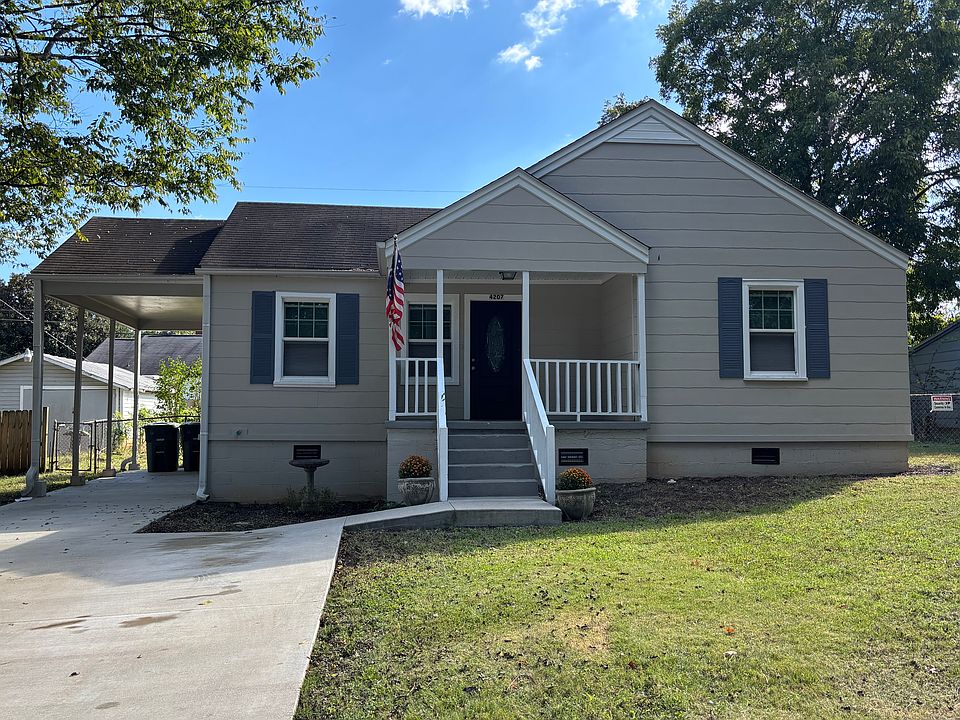 Front View of house; concrete double driveway with carport