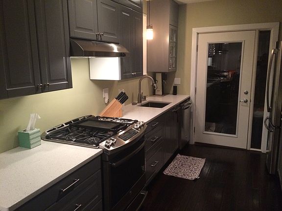 Kitchen features quartz counters and stainless appliances