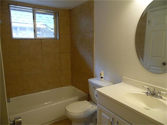 Full bath with updated fixtures and tile backsplah