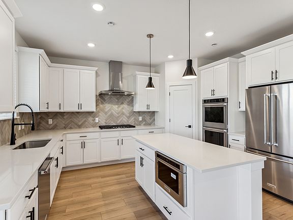 The beautiful kitchen has stainless steel, energy efficient appliances.
