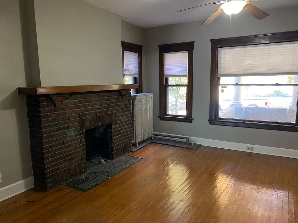 Front room with plenty of light and ceiling fan.