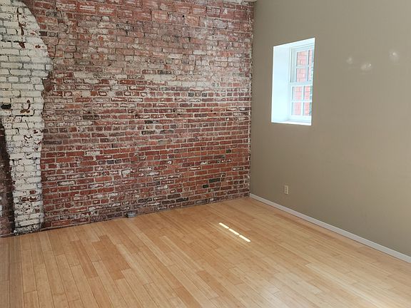 Living area with a charming brick wall.