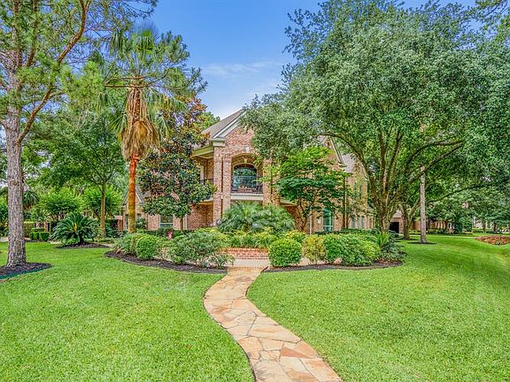 Fabulous curb appeal, with established and fresh landscaping with a front elevation that features a balcony above the impressive entry.