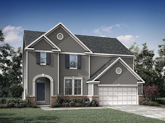 custom two-story home with brick and siding