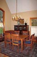Dining room with vaulted ceiling, dramatic arched window
