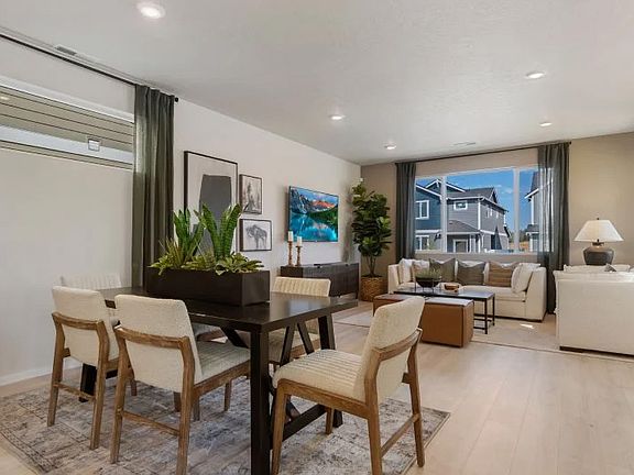 Open-Concept Dining: Strategically placed for easy transitions between the kitchen and the table, making the most of the home's bright and fluid floor plan.