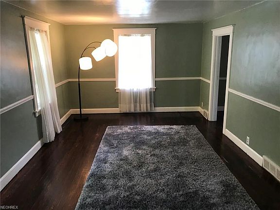 Living room w/dark original hardwood floors.