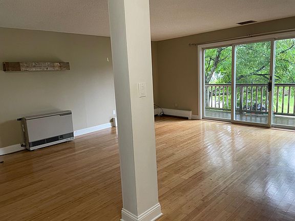 Open living and dining space with slider to front deck