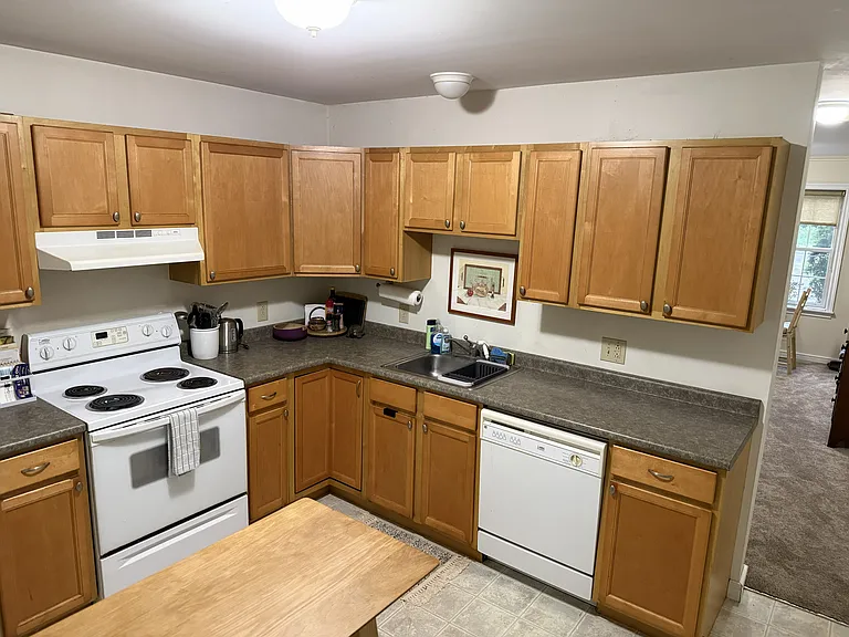 Kitchen includes stove, dishwasher, and refrigerator