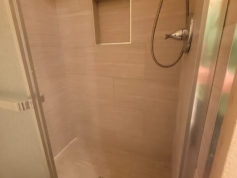 master shower with sliding glass doors.