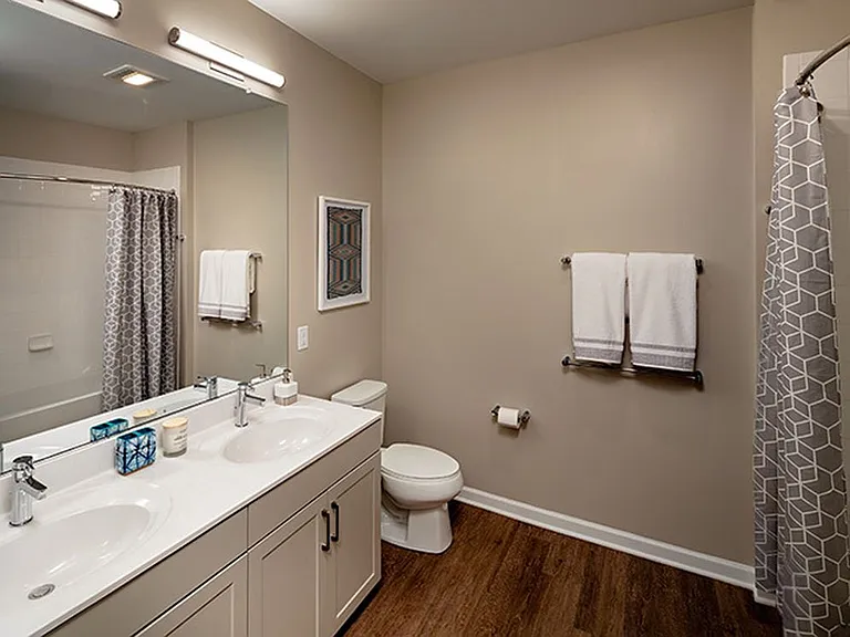 Bath with grey cabinetry, white quartz countertop, and hard surface flooring