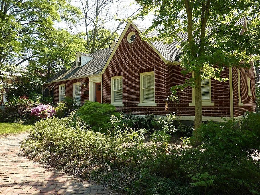 Classic 1930s brick home sits back from the road on almost a 3/4 acre beautifully landscaped lot.