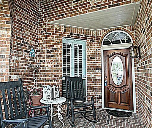 THIS STUNNING COVERED FRONT PORCH WELCOMES YOU HOME