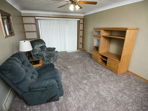 Living room has brand new carpet, built in oak shelving, sliding glass doors to the deck for additio