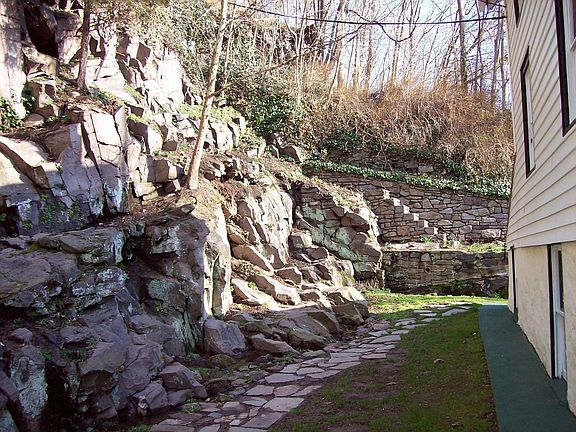 rear garden with rock wall