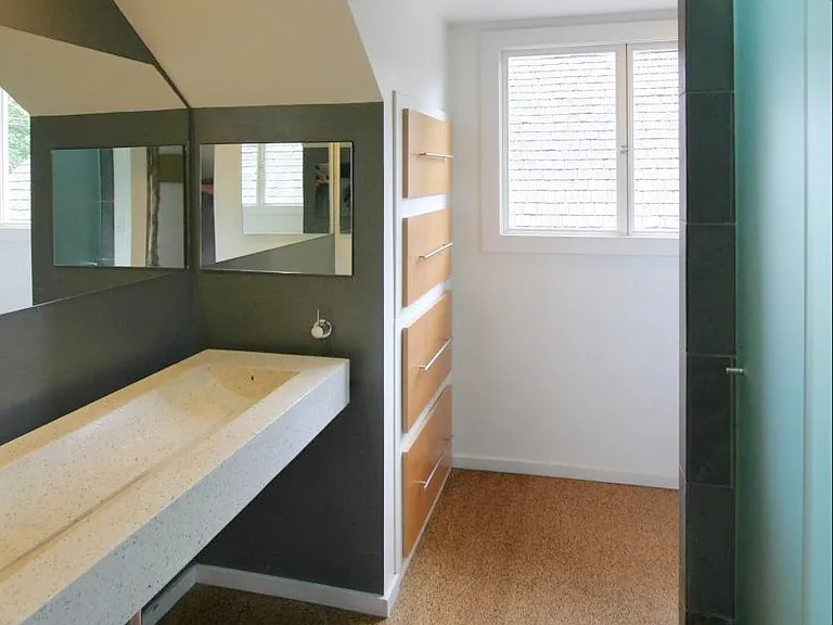 Upstairs bathroom with cork floors, custom trough sink, spa-like shower and lots of storage space.