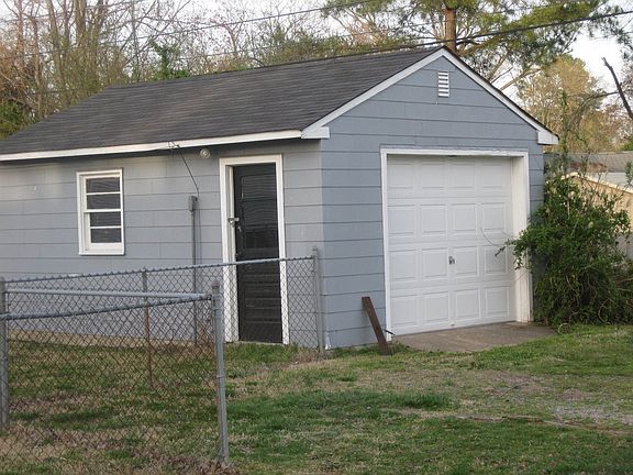 The detached one-car garage has power/lights and workbench areas.