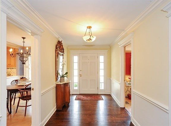 An elegant approach sets the tone for the rest of this beautiful home.  Deep crown molding, baseboar