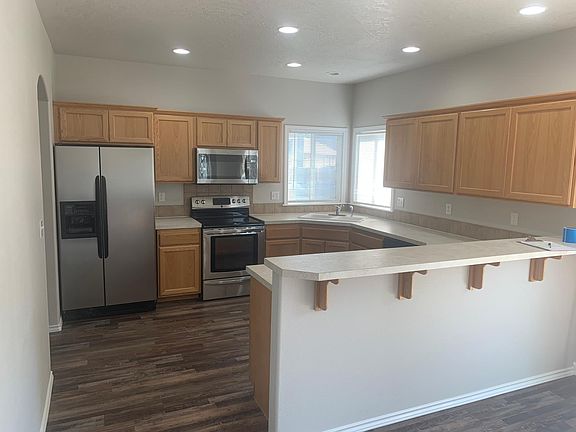 Kitchen with Refrigerator, Microwave, Stove, Dishwasher and Garbage Disposal