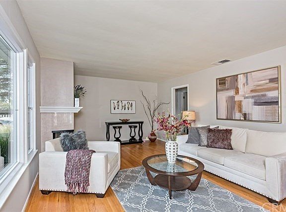 Newer windows, scraped ceilings & gas fireplace in bright living room.