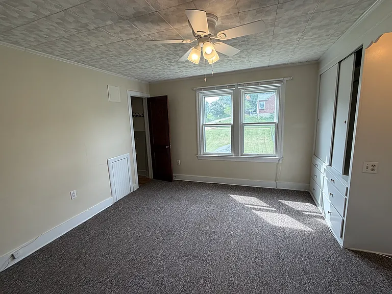 View of rear yard & secondary closet in rear bedroom.