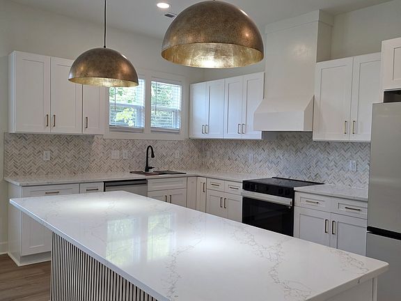 The kitchen has designer quartz where you can set up for a casual meal on the island.