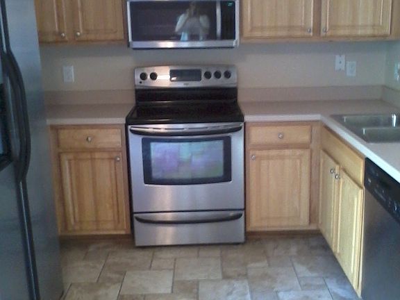 Stainless Steel Appliances and Stampled Tile in Kitchen