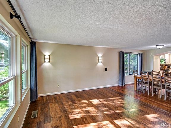 Living room with open concept to dining room and kitchen. Triple pain windows open in for easy cleaning.