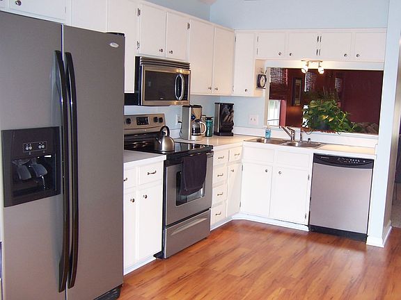 Kitchen with new stainless steel appliances, flooring, lighting, hardware!