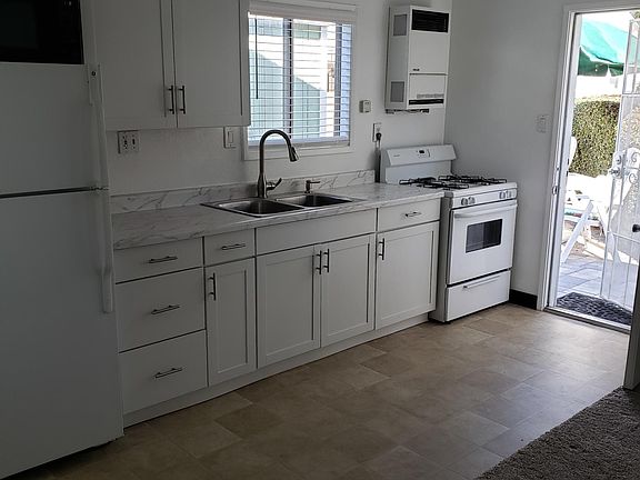 2022 renovated kitchen with microwave, refrigerator, and stove