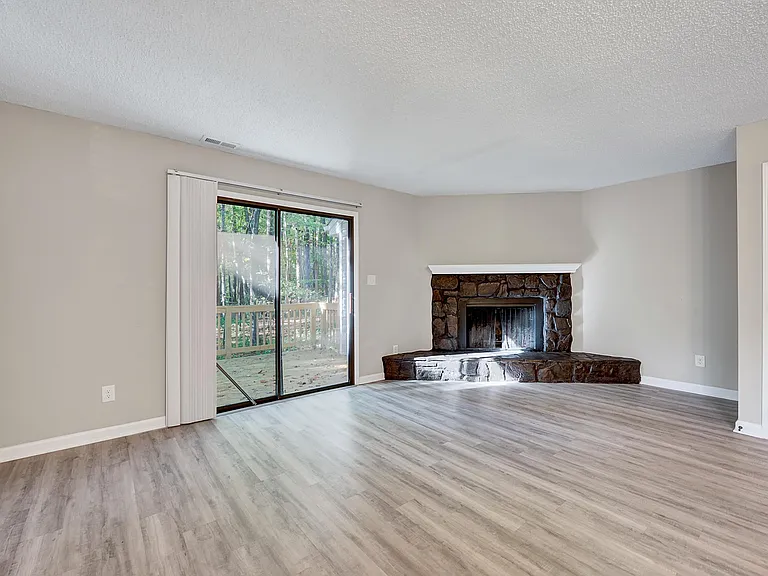 The large open concept living/dining/kitchen has nice views of the back deck and the woods