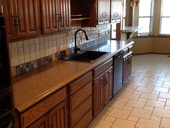 Kitchen has roomy eating nook and open snack bar with pendant lighting!