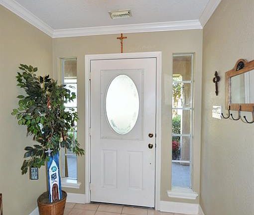 Inviting entry with crown molding and plenty of natural light.