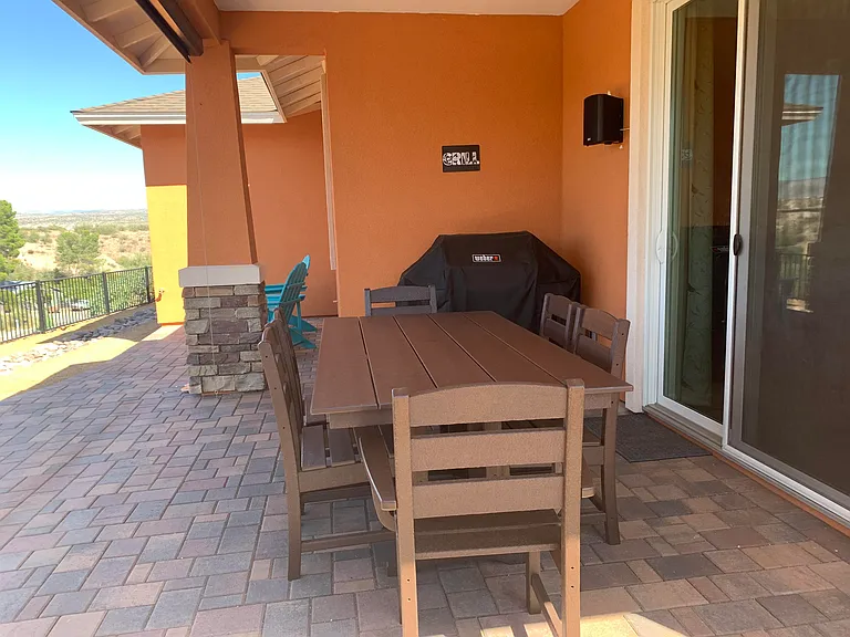 Seating for six at the Polywood dining table and chairs and a almost new Weber genesis gas grill on which to BBQ.