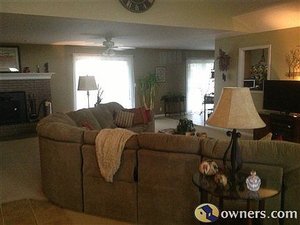 Living area has a fireplace with insert and cathedral ceiling.