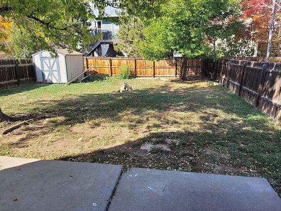 fenced back yard with shed