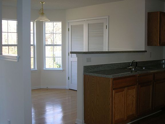 Large breakfast area off kitchen with bay window looking out private backyard.