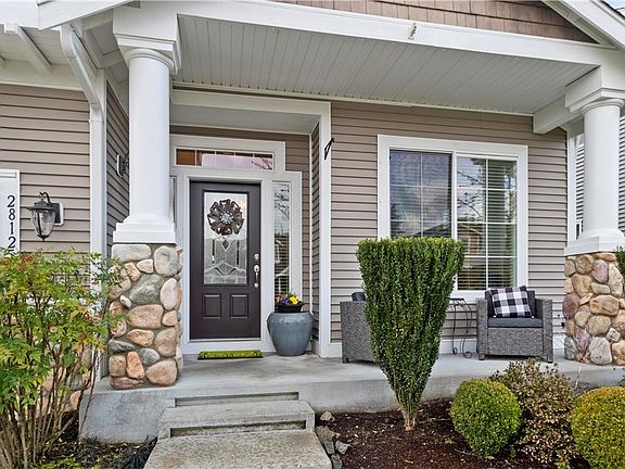 Large covered porch invites you into this beautiful home.