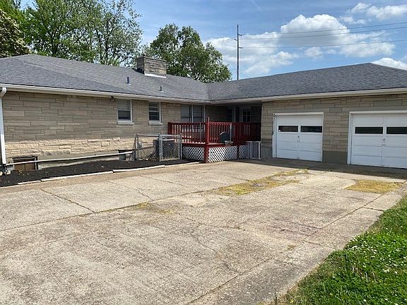 2 car garage with driveway and deck