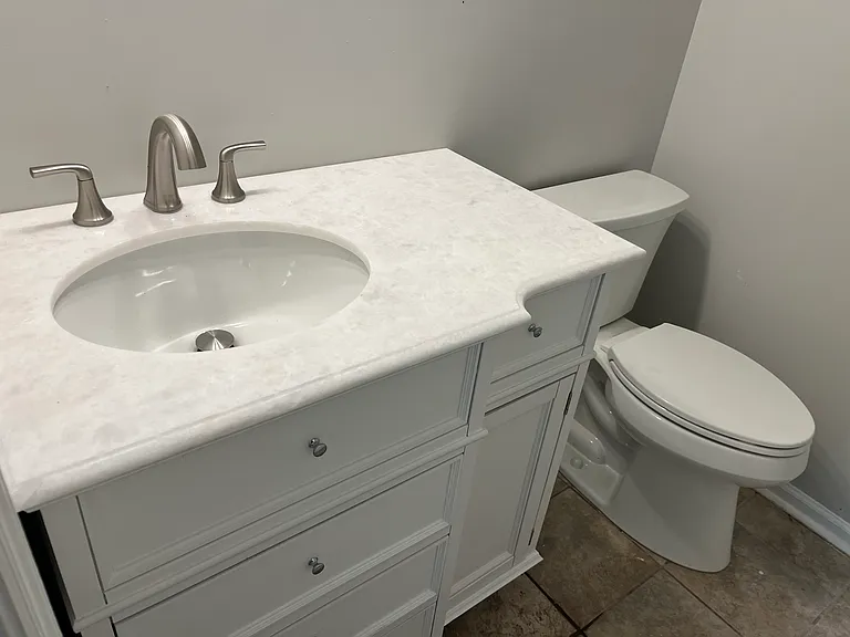 New vanity and toilets in both upstair bedroom bathroom. Refinished bathtub.