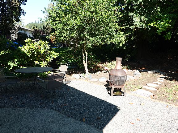 BACK PATIO WITH A SHORT TRAIL TO CREEK.