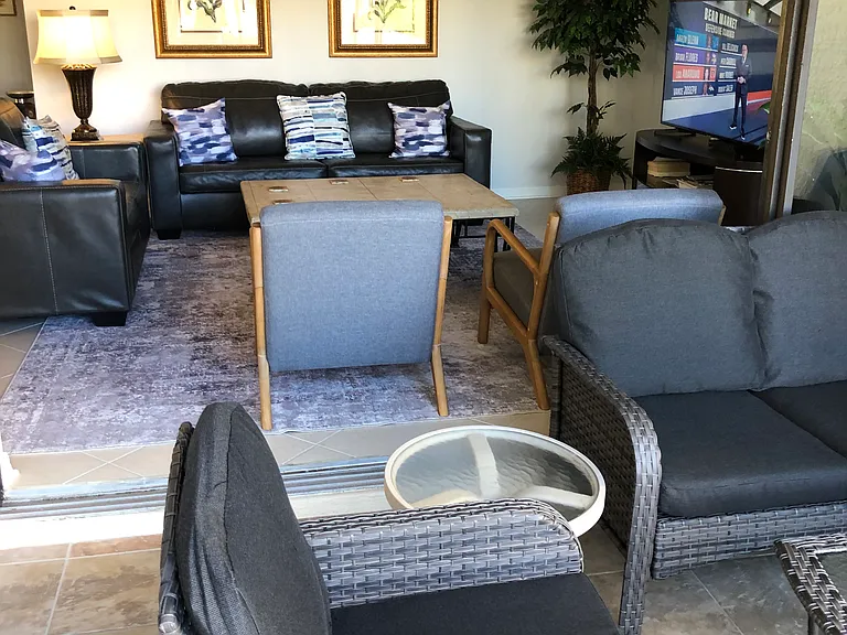 View from lanai into living room with 3-door sliders open for expanded living area.