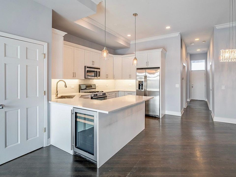 Custom kitchen with stainless steel appliances and quartz countertop