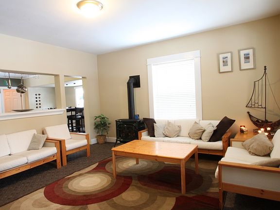 The living room is open to the kitchen via a large windowless window between the two rooms.