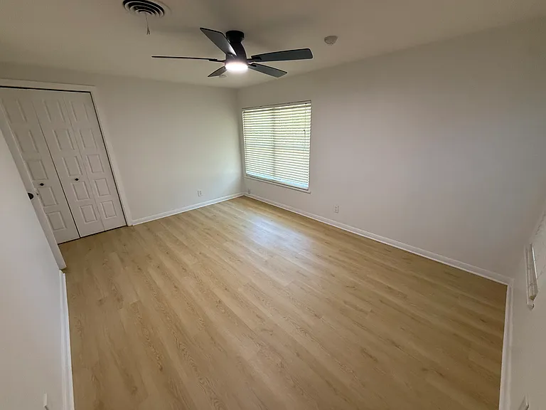Back bedroom with luxury vinyl plank, two windows