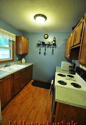 Kitchen - All kitchen appliances stay. (Dishwasher, refrigerator, oven and microwave.) Photograph ta