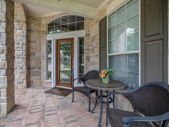 Gorgeous stone and brick elevation with a charming brick lined front porch.