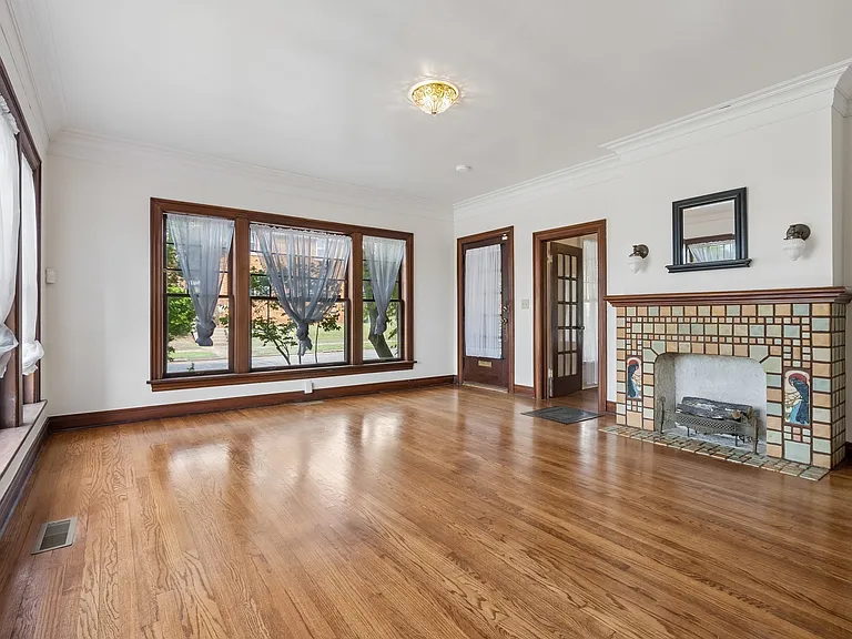 Living room looking toward main entrance door on left and bedroom 1 door on right