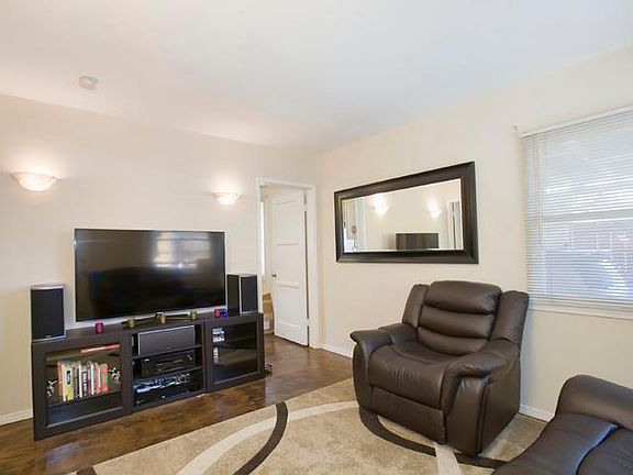 Bright and clean living room off entrance with polished concrete floors.