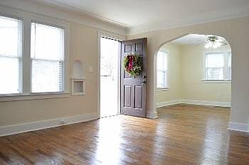 Welcome home!  The brand new front door deck area leads into the open living room (16x13) and dining room areas.  Notice the original cove ceilings and stylish wall design.